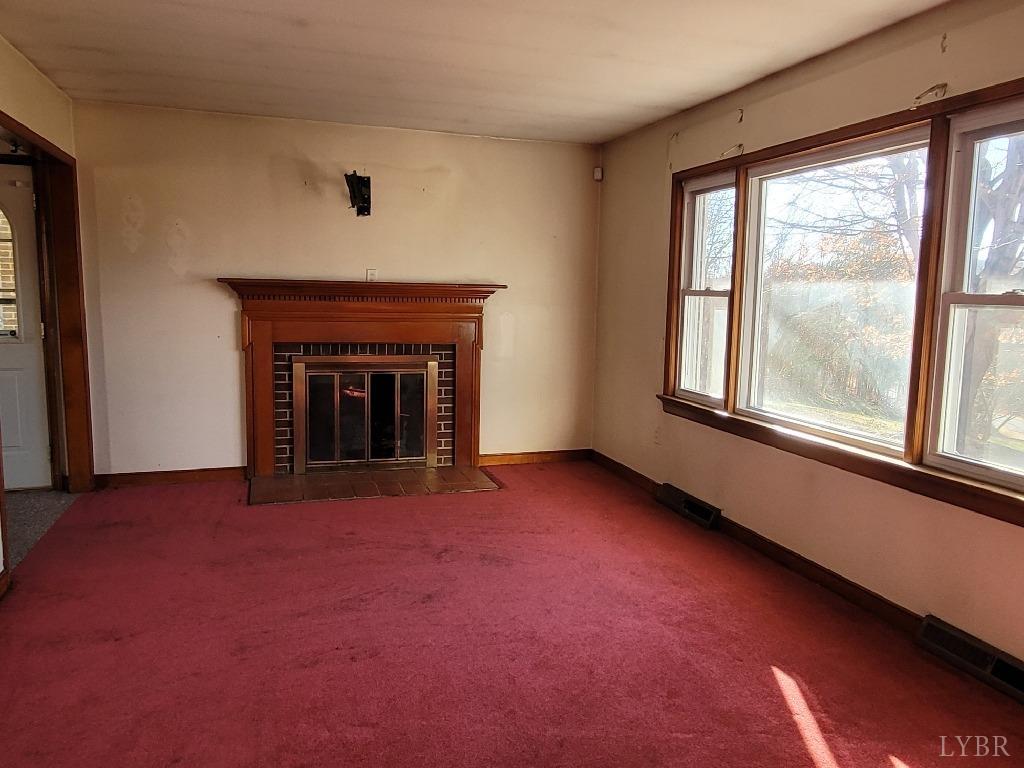 1025 Country Club Road Hurt, VA 24563 - Photo 10 of 15 an empty room with fireplace