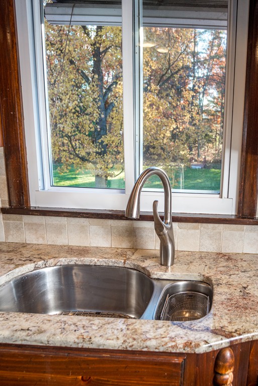 50 Mueller Road Holyoke, MA 01040 - Photo 12 of 30 a view with a sink a window and a kitchen island with granite countertops