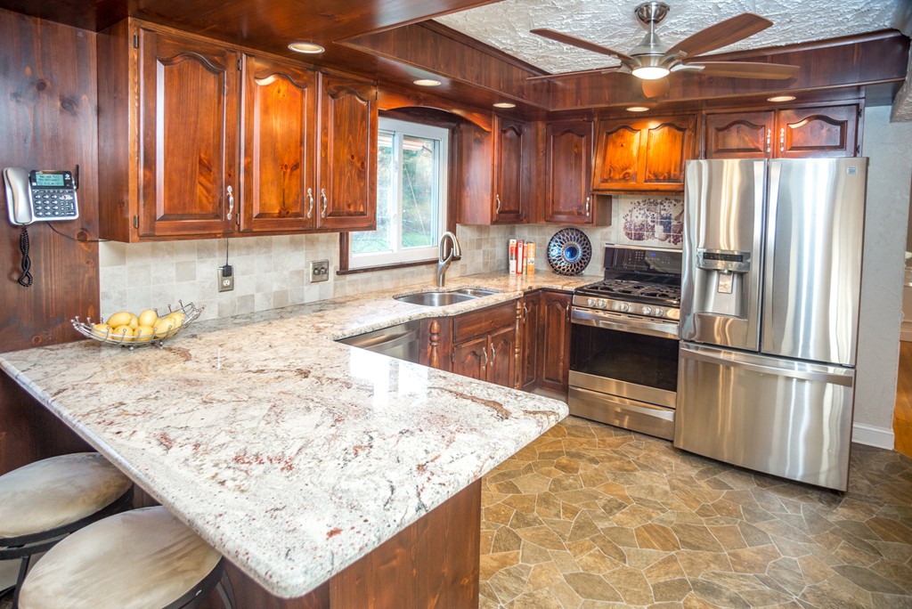 50 Mueller Road Holyoke, MA 01040 - Photo 14 of 30 a kitchen with stainless steel appliances granite countertop a sink refrigerator and cabinets