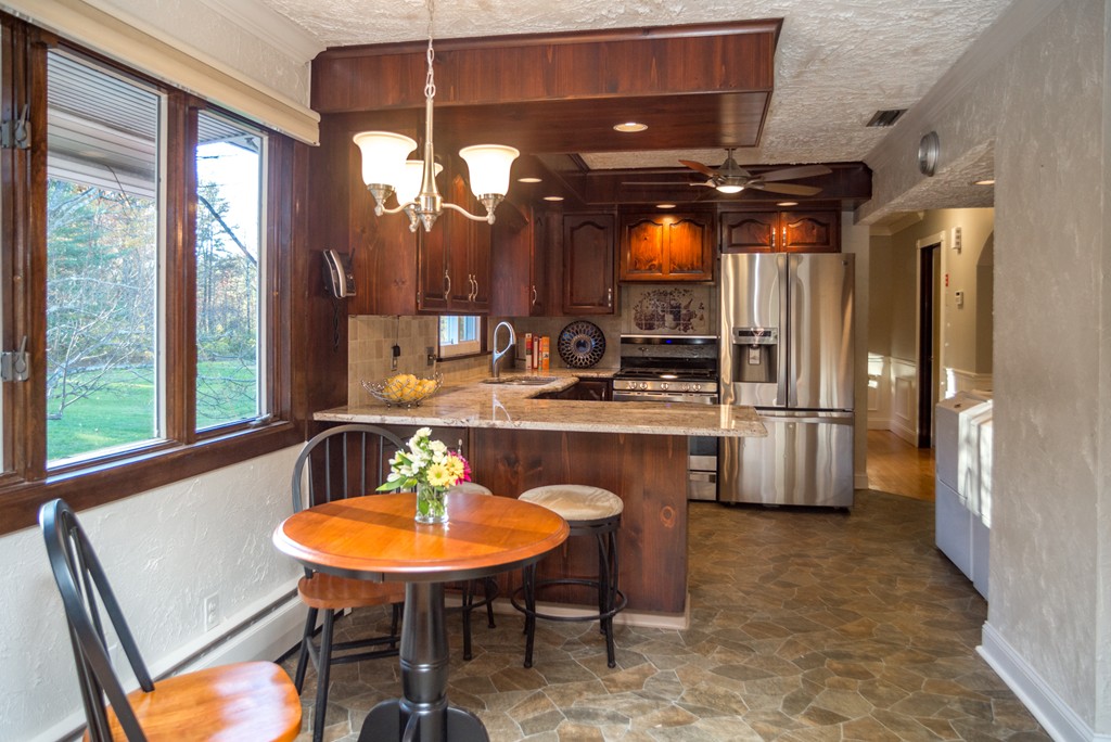 50 Mueller Road Holyoke, MA 01040 - Photo 10 of 30 a kitchen with a table chairs sink and cabinets