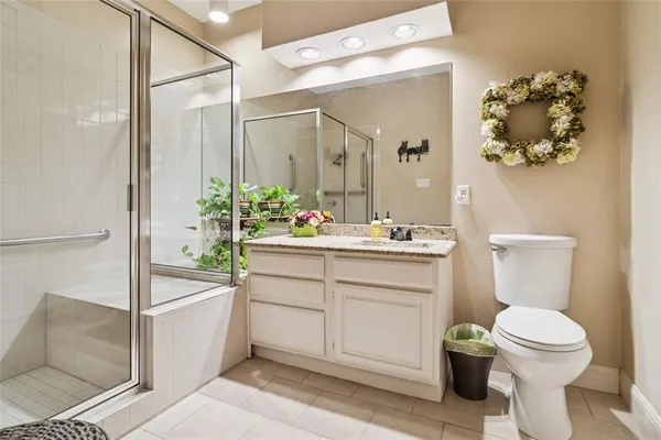 a bathroom with a sink mirror vanity and toilet