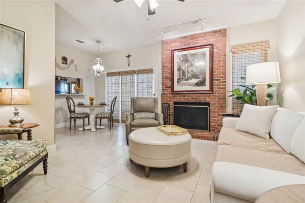 a living room with furniture a fireplace and a table