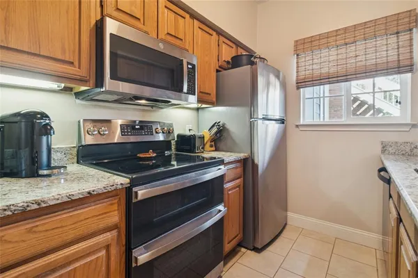 a kitchen with stainless steel appliances granite countertop a stove microwave and refrigerator
