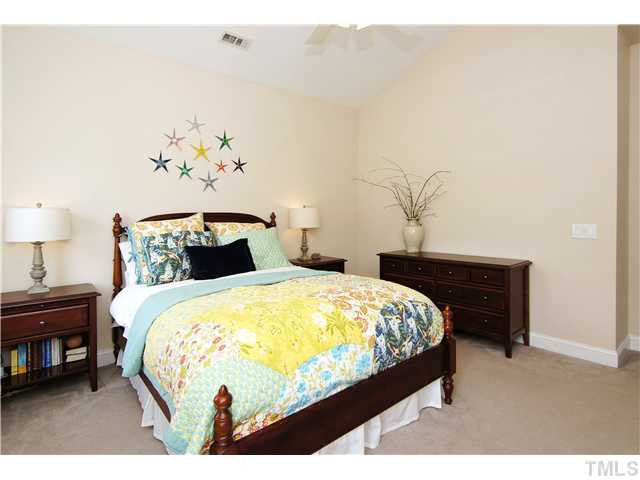 6 Kilary Drive Durham, NC 27713 - Photo 16 of 25 a bed sitting in a bedroom next to a lamp