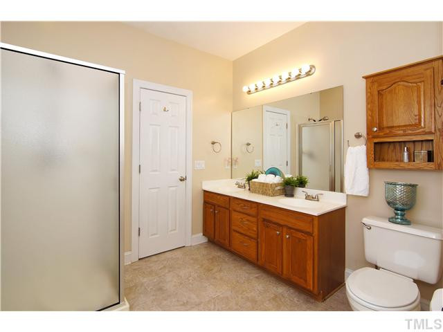 6 Kilary Drive Durham, NC 27713 - Photo 17 of 25 a bathroom with a double vanity sink toilet mirror and bathtub