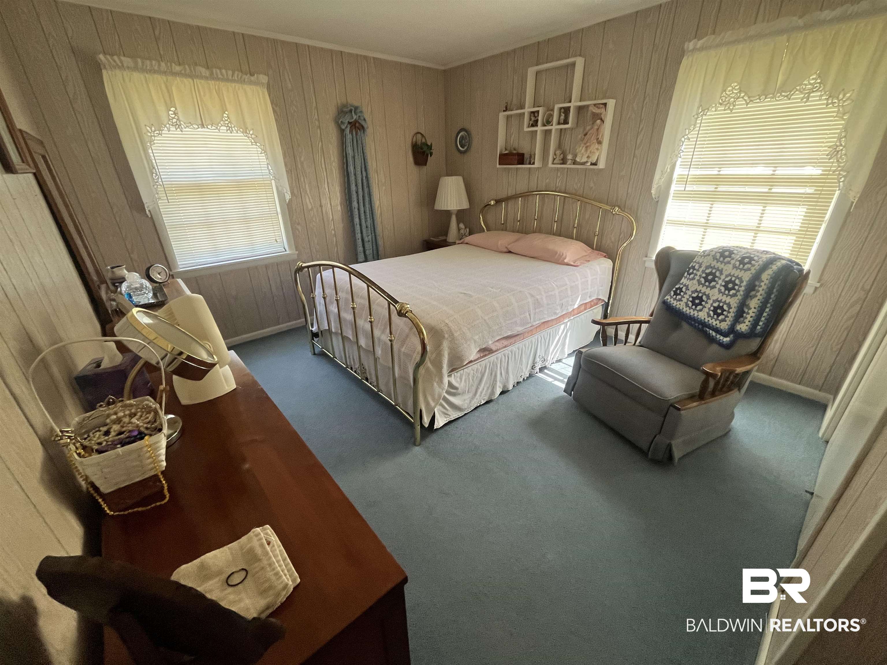 315 Dawkins Road Brewton, AL 36426 - Photo 17 of 19 Carpeted bedroom with crown molding, wood walls, and baseboards