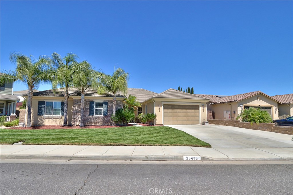 28483 Nautical Point Circle Menifee, CA 92585 - Photo 1 of 44 a front view of a house with a garden and yard