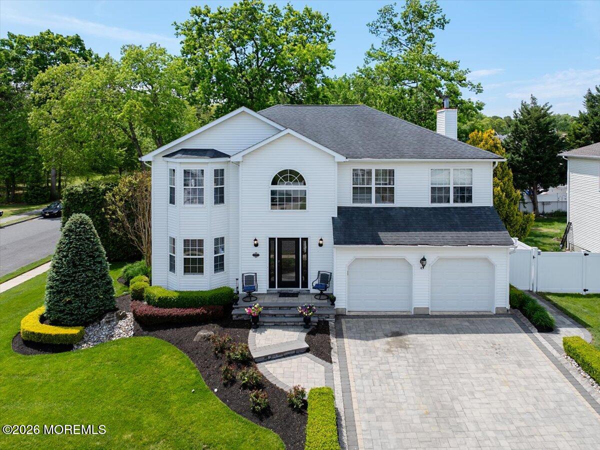 49 Diamond Lane Howell, NJ 07731 - Photo 1 of 46 a view of a white house with a yard plants and large tree
