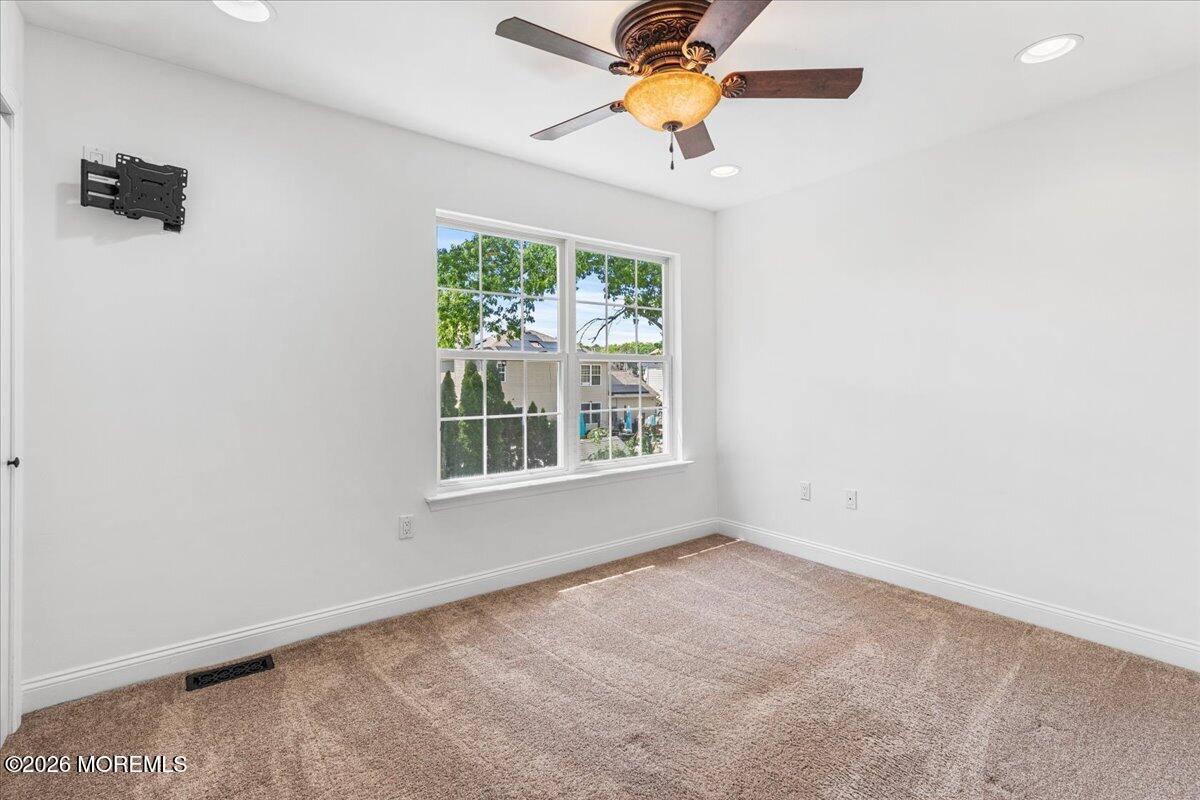 49 Diamond Lane Howell, NJ 07731 - Photo 26 of 46 an empty room with a window and a ceiling fan
