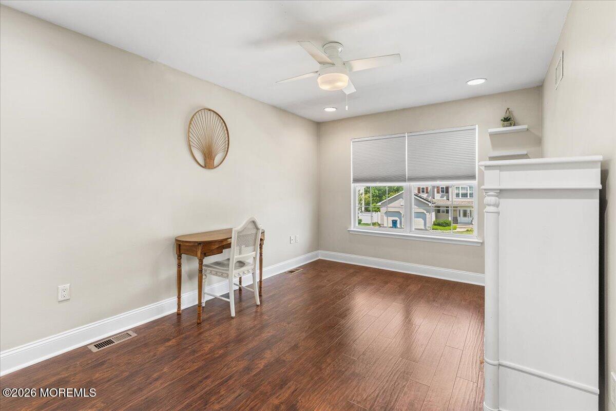 49 Diamond Lane Howell, NJ 07731 - Photo 27 of 46 an empty room with wooden floor and windows