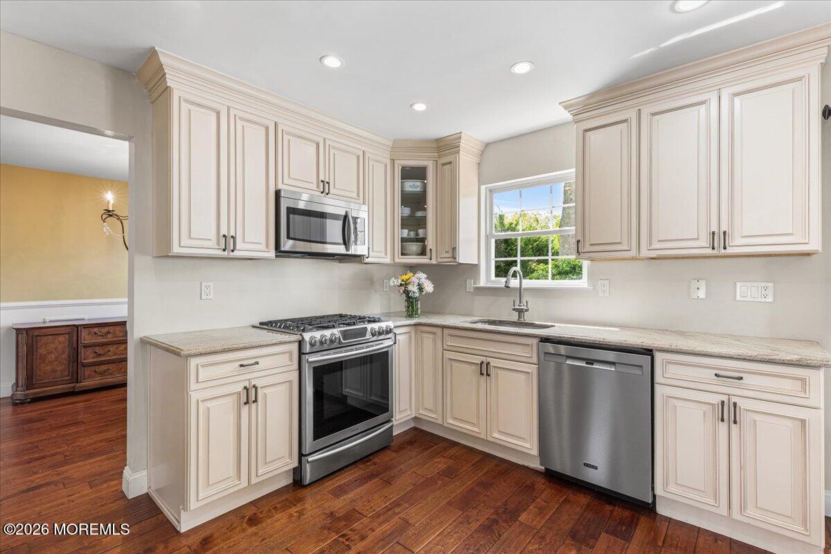 49 Diamond Lane Howell, NJ 07731 - Photo 8 of 46 a kitchen with cabinets stainless steel appliances a sink and wooden floor