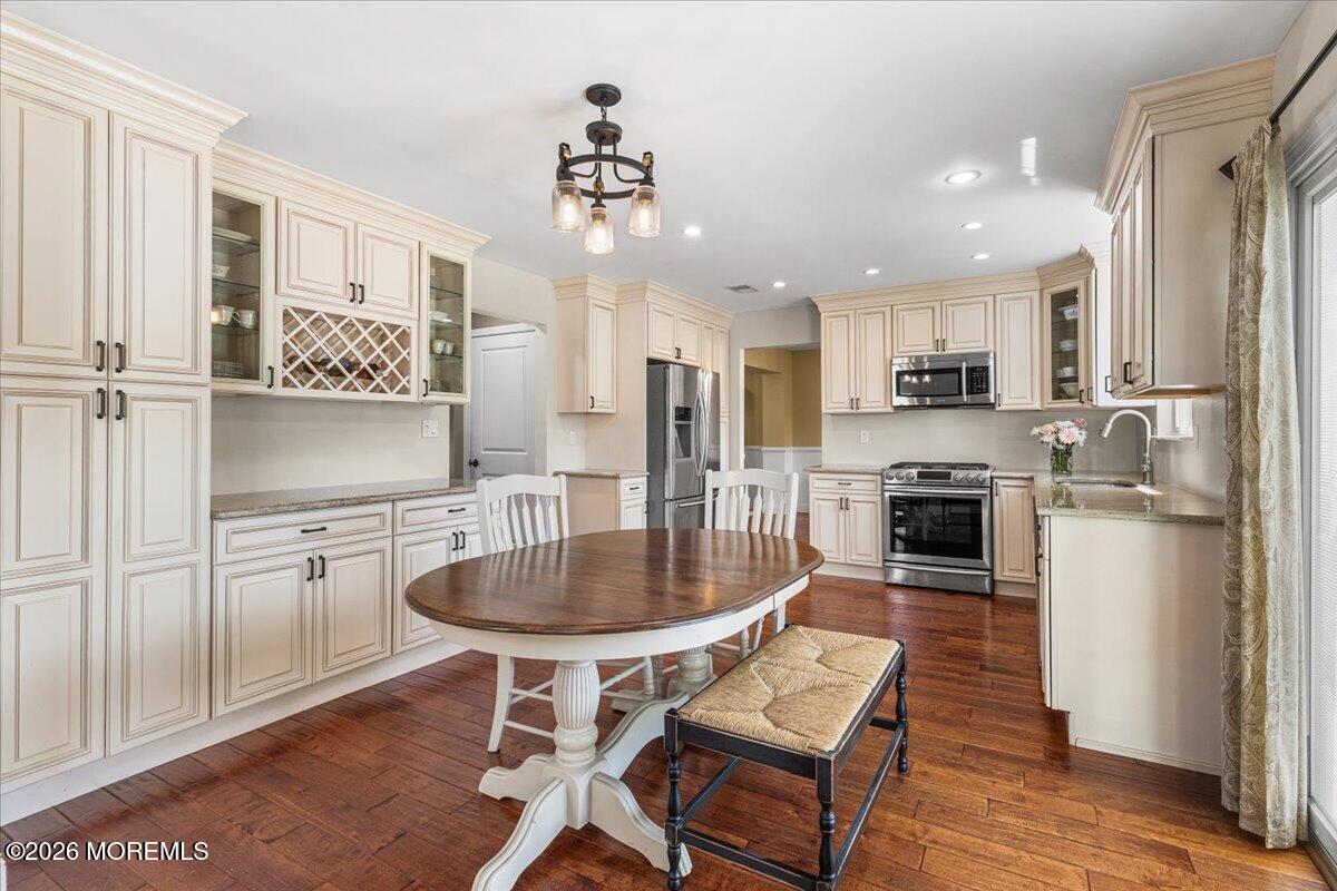 49 Diamond Lane Howell, NJ 07731 - Photo 9 of 46 a kitchen with stainless steel appliances granite countertop a stove a sink a refrigerator dining table and chairs