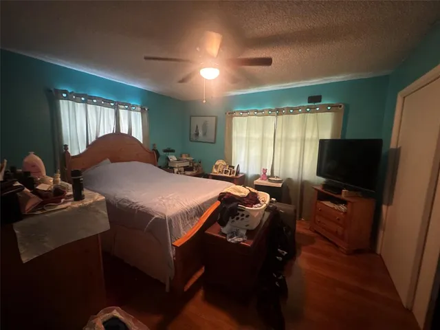 a bed room with a bed and a television