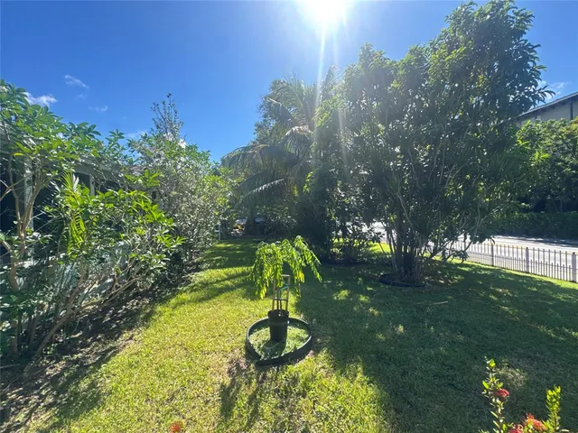 a backyard of a house with lots of green space and garden view