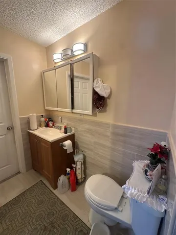a bathroom with a sink mirror and toilet