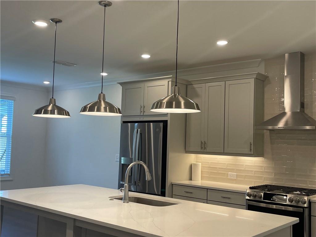 4807 Larkin Pass Buford, GA 30518 - Photo 12 of 58 a kitchen with kitchen island a sink stainless steel appliances and cabinets