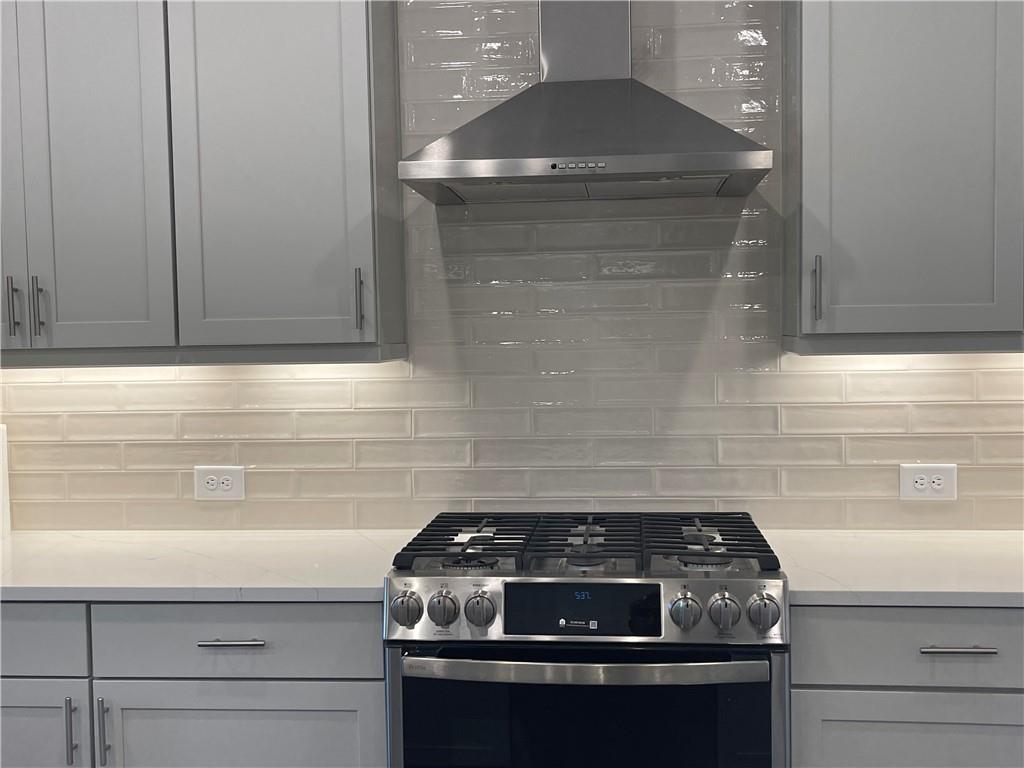 4807 Larkin Pass Buford, GA 30518 - Photo 14 of 58 a stove top oven sitting inside of a kitchen