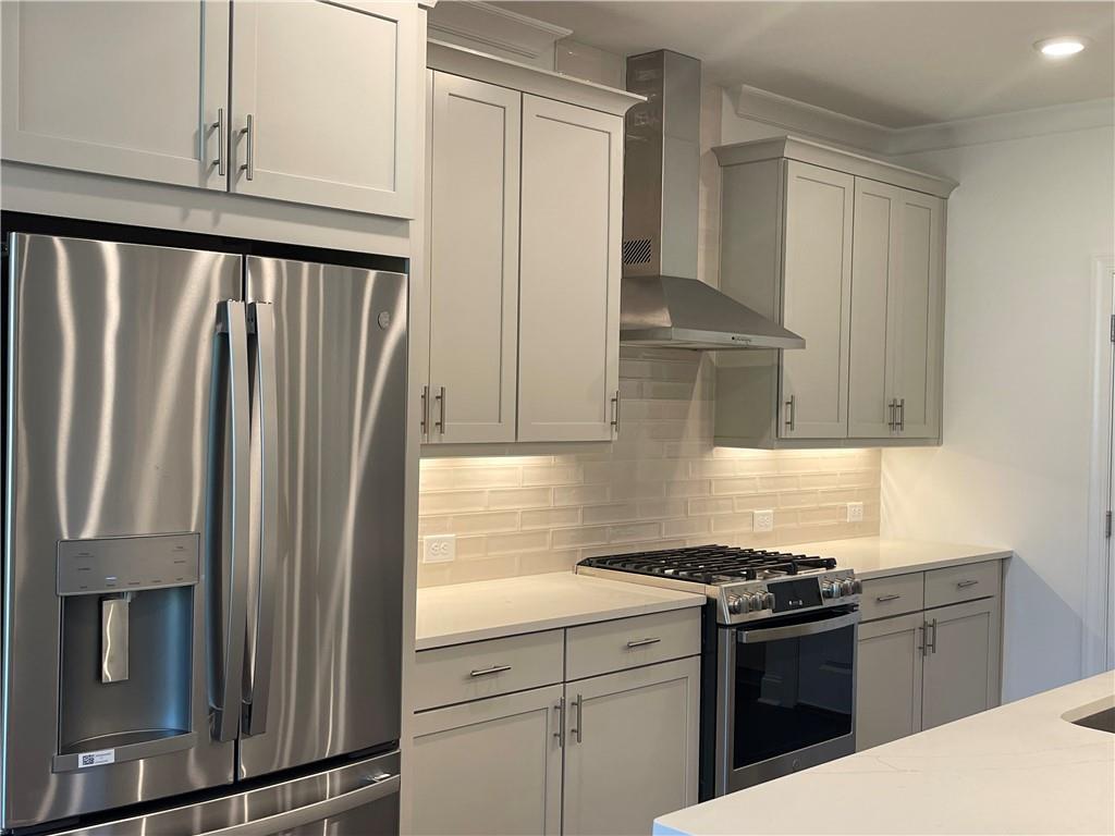 4807 Larkin Pass Buford, GA 30518 - Photo 15 of 58 a kitchen with granite countertop a refrigerator stove and cabinets