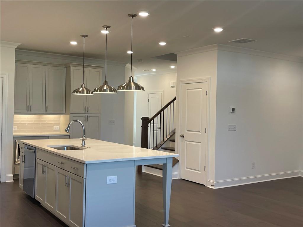 4807 Larkin Pass Buford, GA 30518 - Photo 17 of 58 a kitchen with a sink a refrigerator and white cabinets
