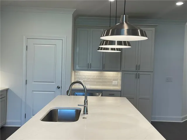 a kitchen with a sink cabinets and window