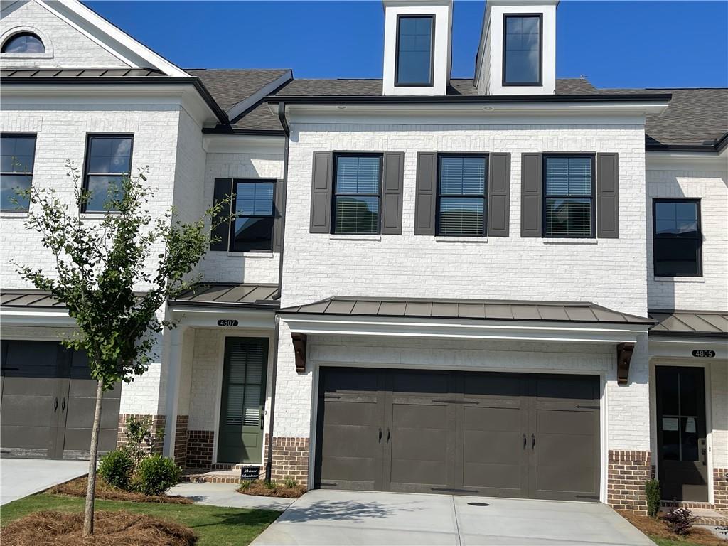 4807 Larkin Pass Buford, GA 30518 - Photo 2 of 58 a front view of a house with a garage