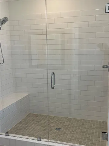 a white toilet sitting next to a white tub