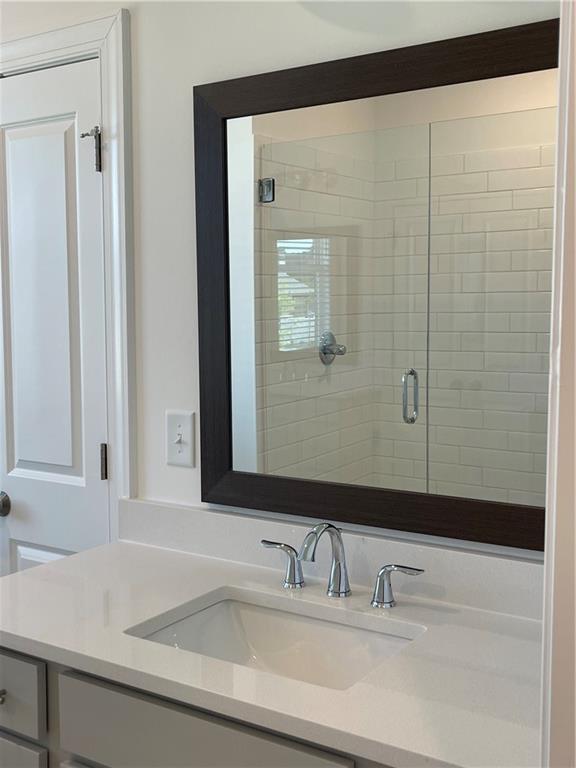 4807 Larkin Pass Buford, GA 30518 - Photo 37 of 58 a bathroom with a sink and a mirror