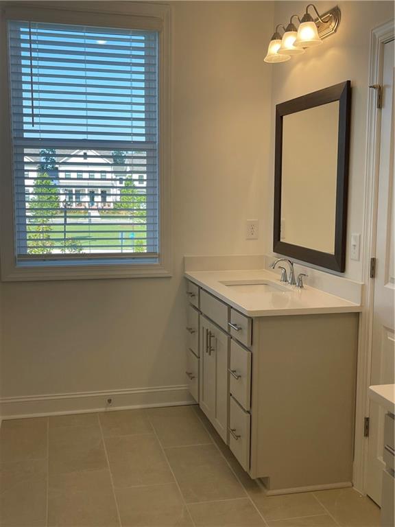 4807 Larkin Pass Buford, GA 30518 - Photo 38 of 58 a bathroom with a sink vanity and a mirror