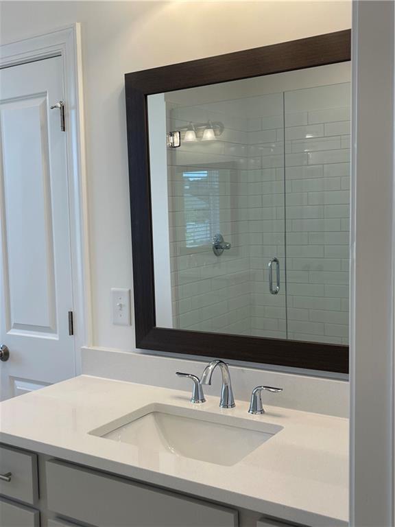4807 Larkin Pass Buford, GA 30518 - Photo 39 of 58 a bathroom with a sink and a mirror