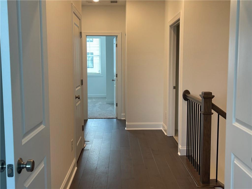 4807 Larkin Pass Buford, GA 30518 - Photo 44 of 58 a view of a hallway with wooden floor