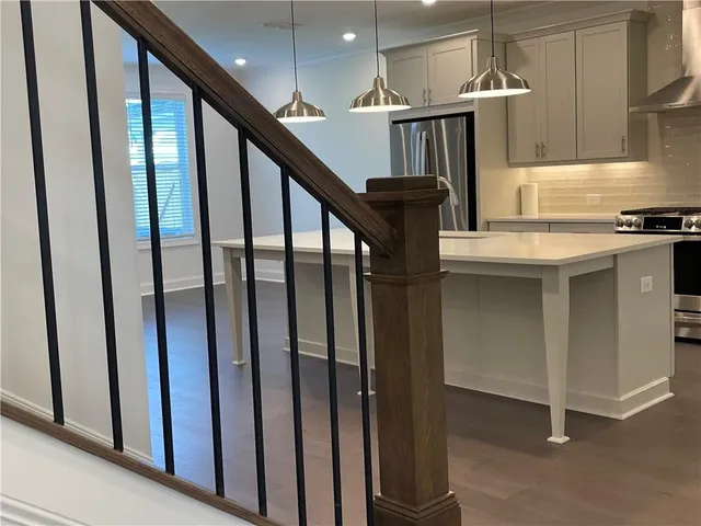a kitchen with granite countertop a stove a sink and a granite counter tops