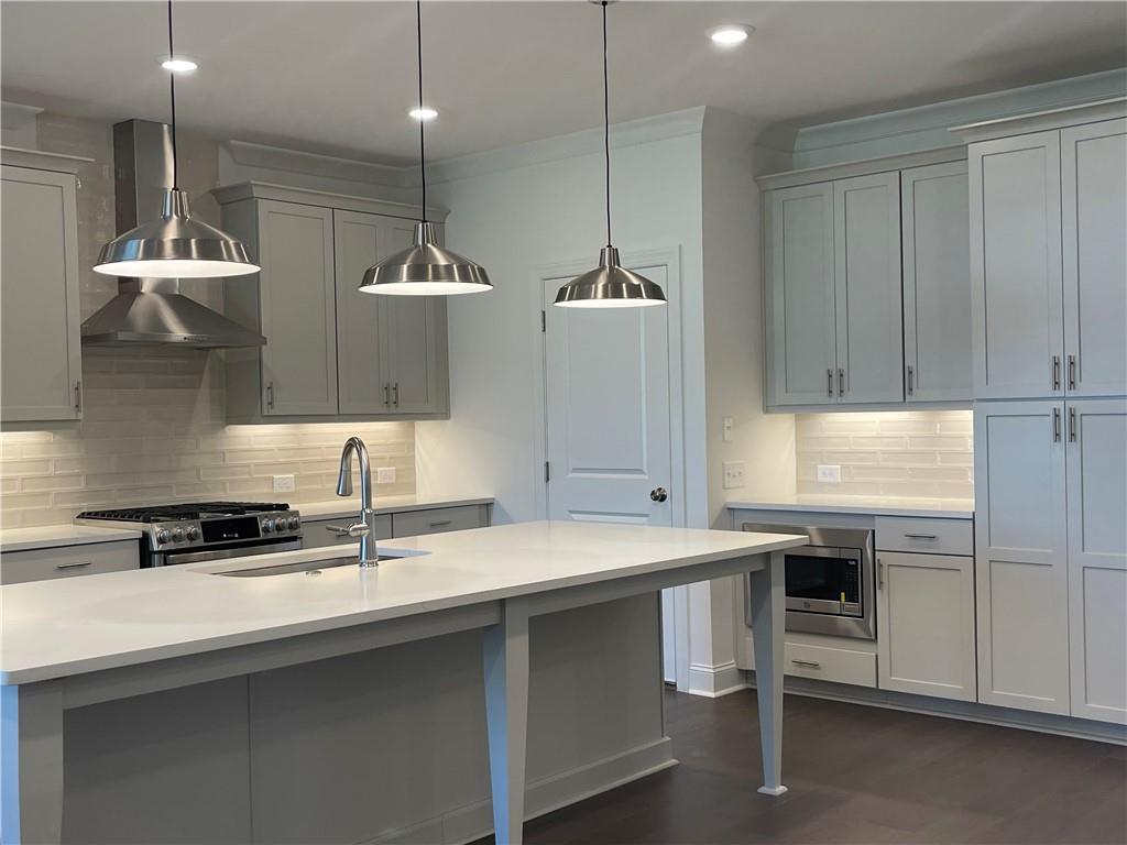 4807 Larkin Pass Buford, GA 30518 - Photo 10 of 58 a kitchen with a sink a counter space appliances and cabinets