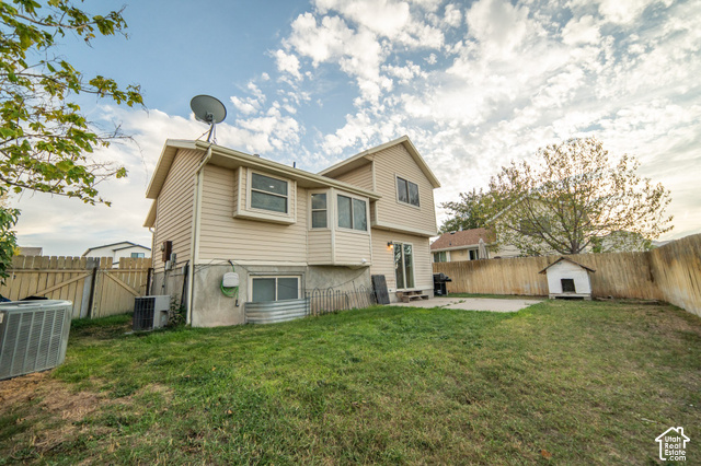 7676 Jefferson Road Magna, UT 84044 - Photo 24 of 24 Expansive backyard featuring a manicured lawn, full fencing, and a concrete patio