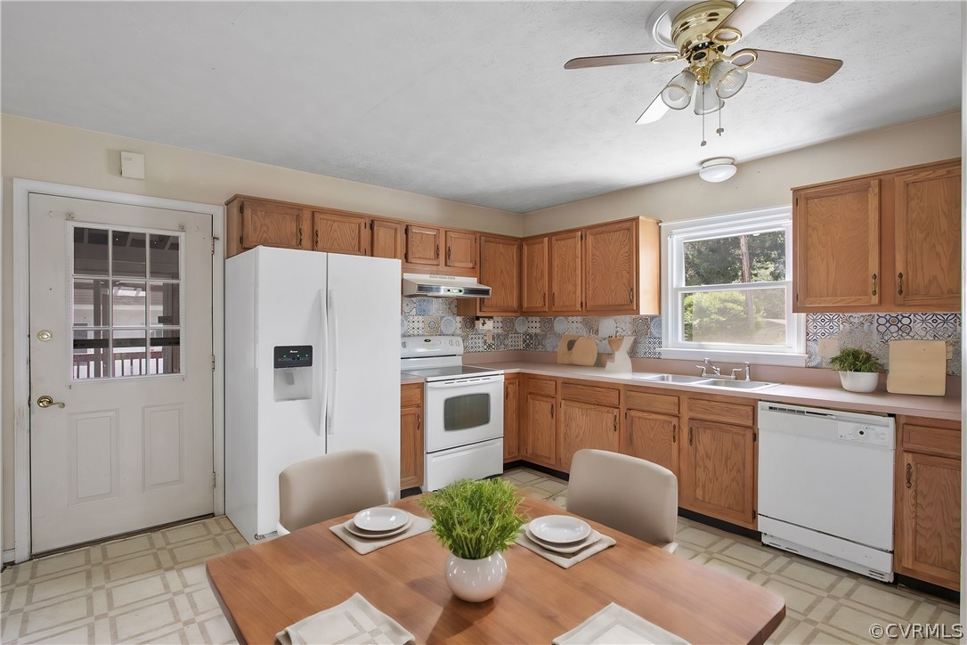 3800 Bailey Farm Road Moseley, VA 23120 - Photo 10 of 48 a kitchen with stainless steel appliances a refrigerator a sink a stove a dining table and chairs