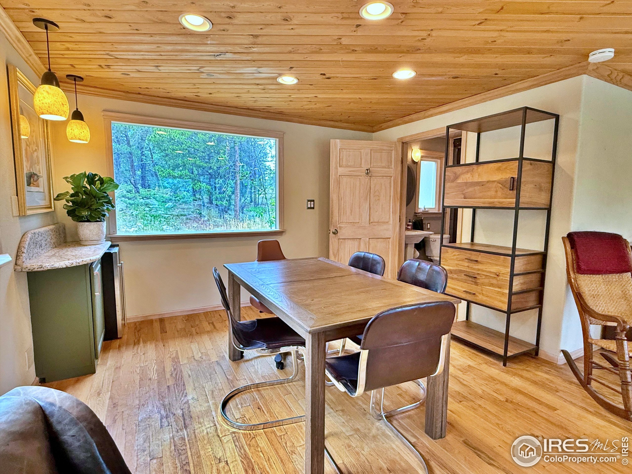 84 Ranch Road Ward, CO 80481 - Photo 12 of 45 a view of a dining room with furniture window and wooden floor