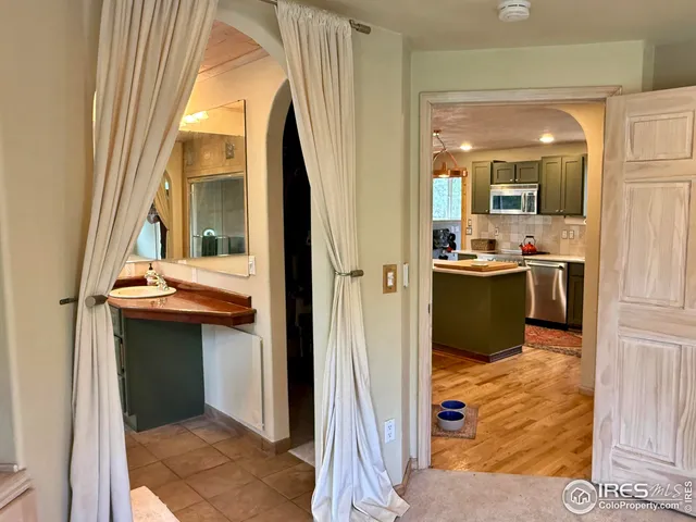 a kitchen view with a sink and refrigerator