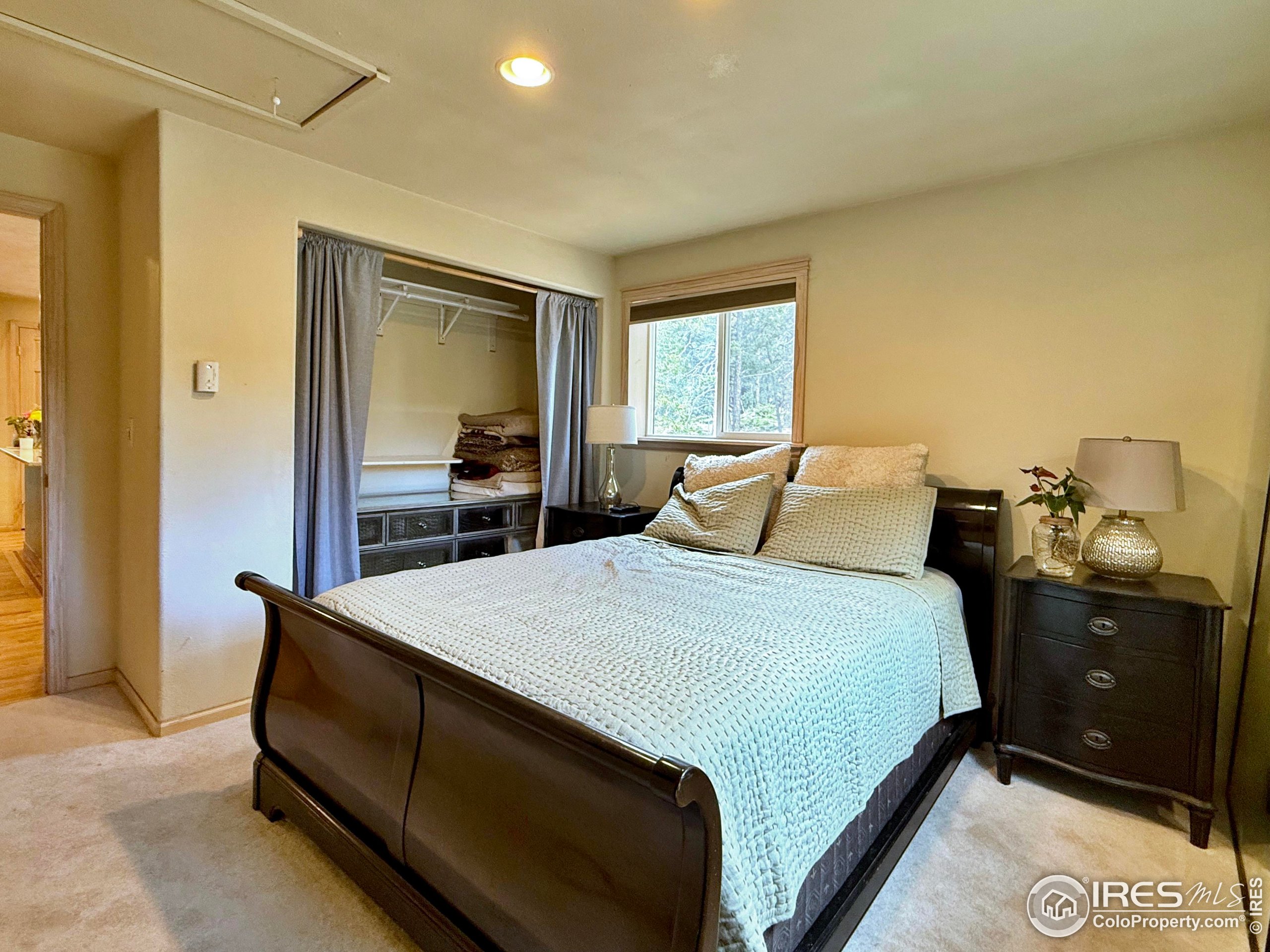 84 Ranch Road Ward, CO 80481 - Photo 17 of 45 a bedroom with a bed and a dresser
