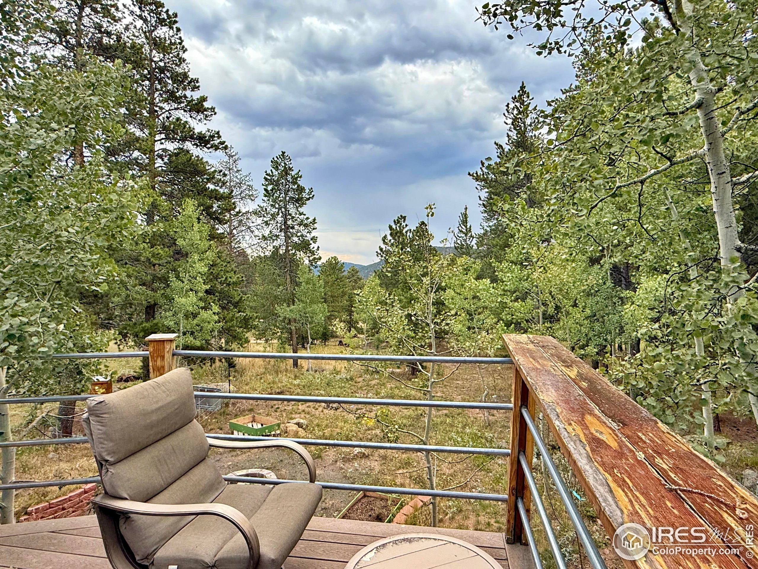 84 Ranch Road Ward, CO 80481 - Photo 20 of 45 a view of a roof deck with couches and sky view