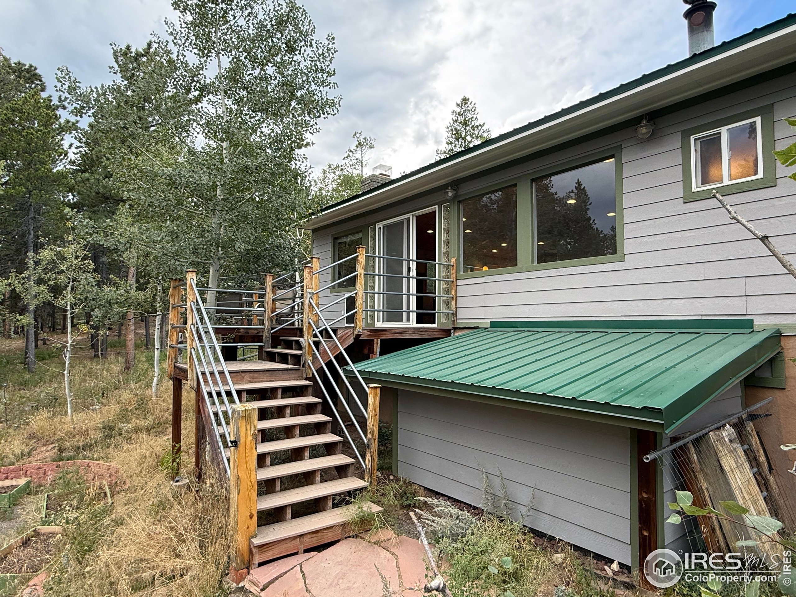 84 Ranch Road Ward, CO 80481 - Photo 21 of 45 a backyard of a house with lots of green space