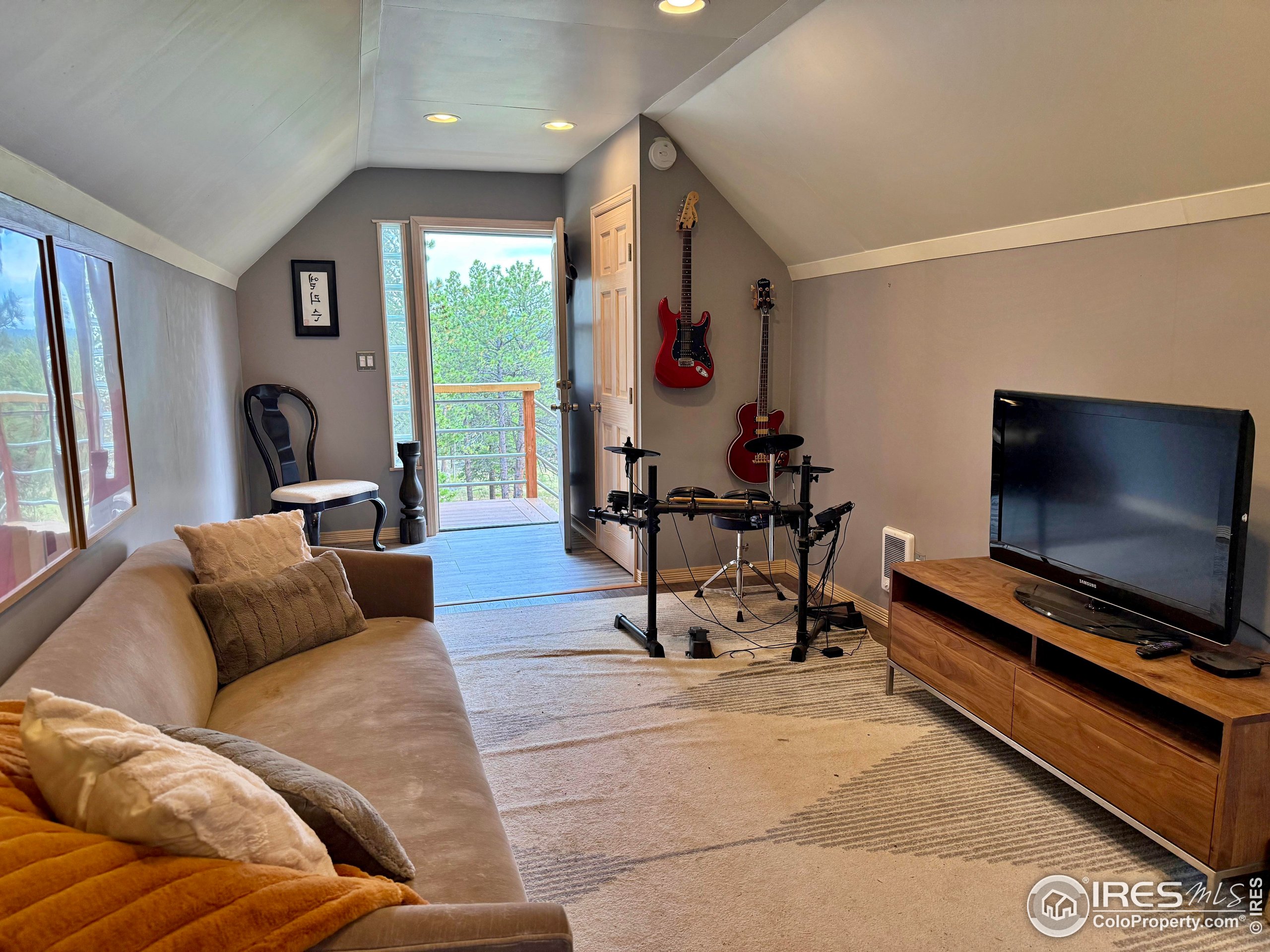 84 Ranch Road Ward, CO 80481 - Photo 24 of 45 a living room with furniture and a flat screen tv
