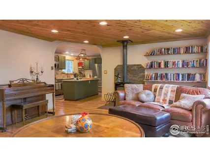 a living room with furniture a flat screen tv and a floor