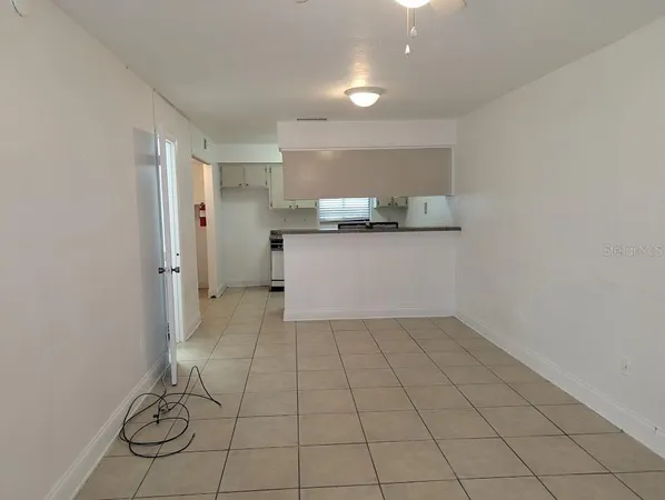 a view of a kitchen with a sink and cabinets