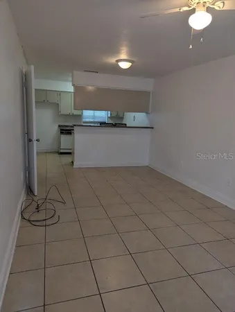 a kitchen with granite countertop a sink cabinets and stainless steel appliances