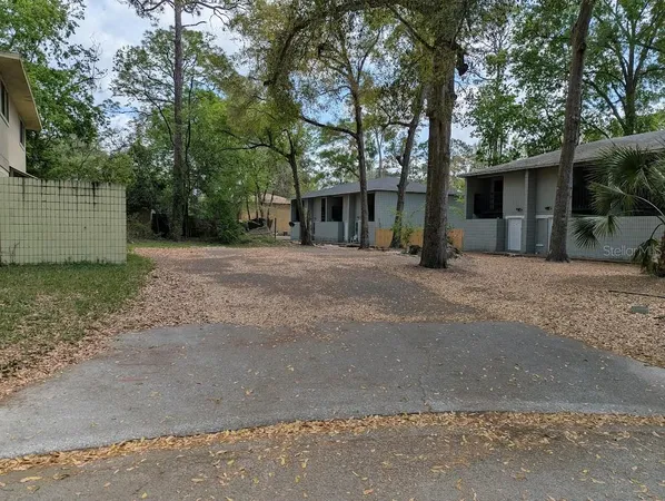 a front view of a house with a yard and a garage