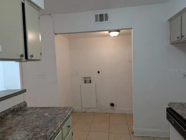a view of a livingroom with an empty space and a window