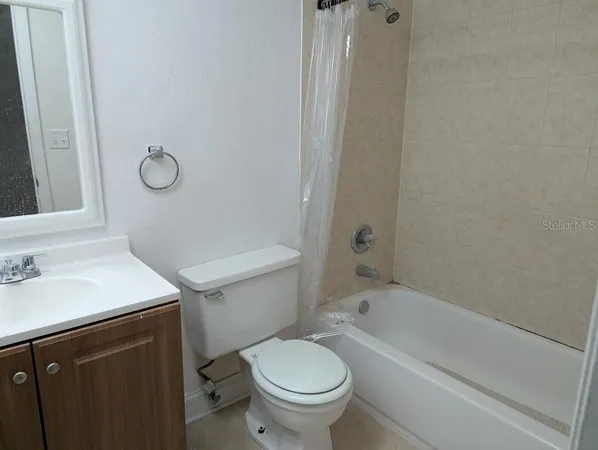 a bathroom with a sink toilet vanity and shower