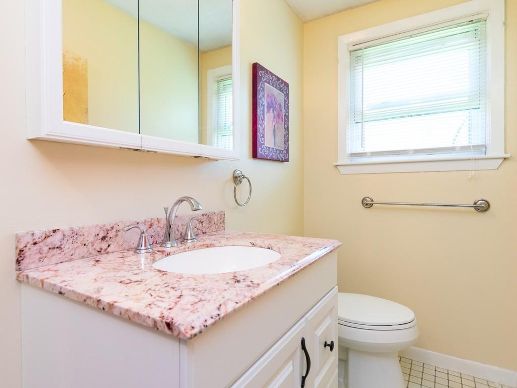 93 Graymore Road Waltham, MA 02451 - Photo 14 of 32 a bathroom with a sink a toilet and a mirror