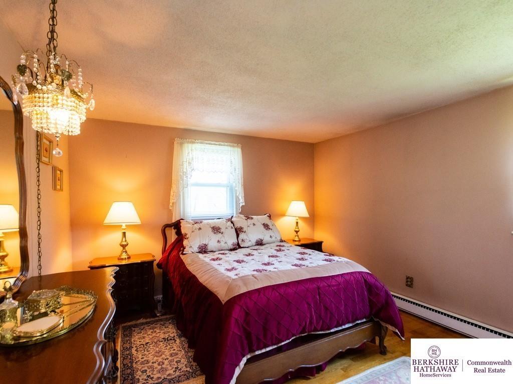 93 Graymore Road Waltham, MA 02451 - Photo 18 of 32 a bedroom with a bed and a chandelier