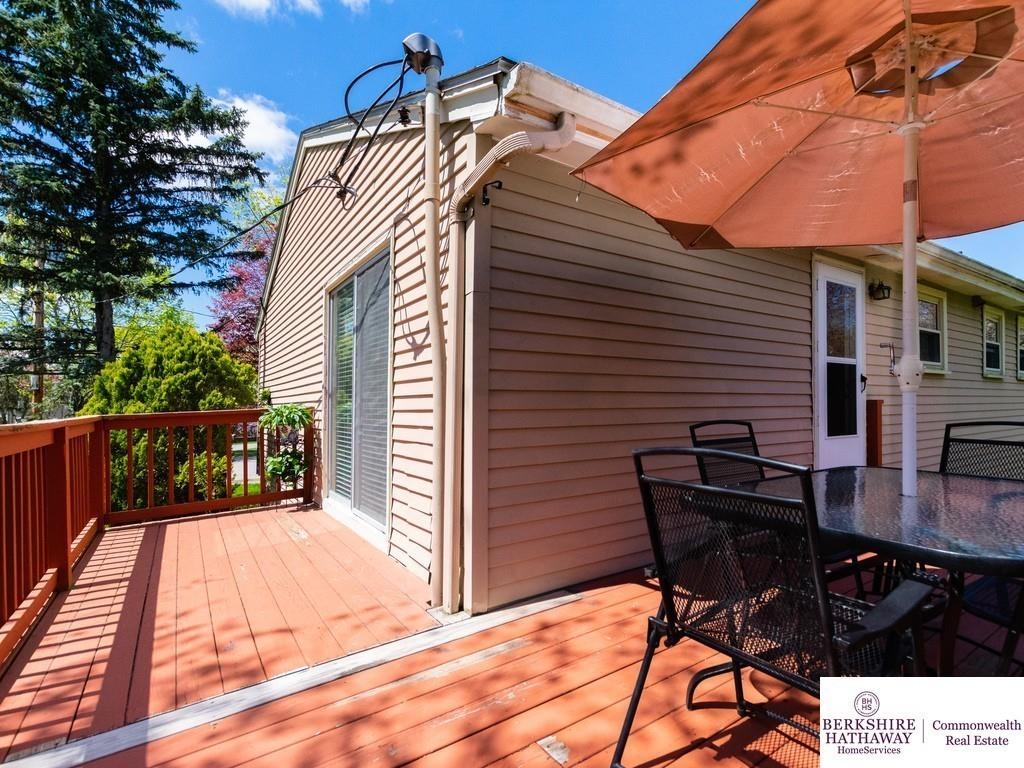 93 Graymore Road Waltham, MA 02451 - Photo 21 of 32 a view of a patio with table and chairs with wooden floor and fence