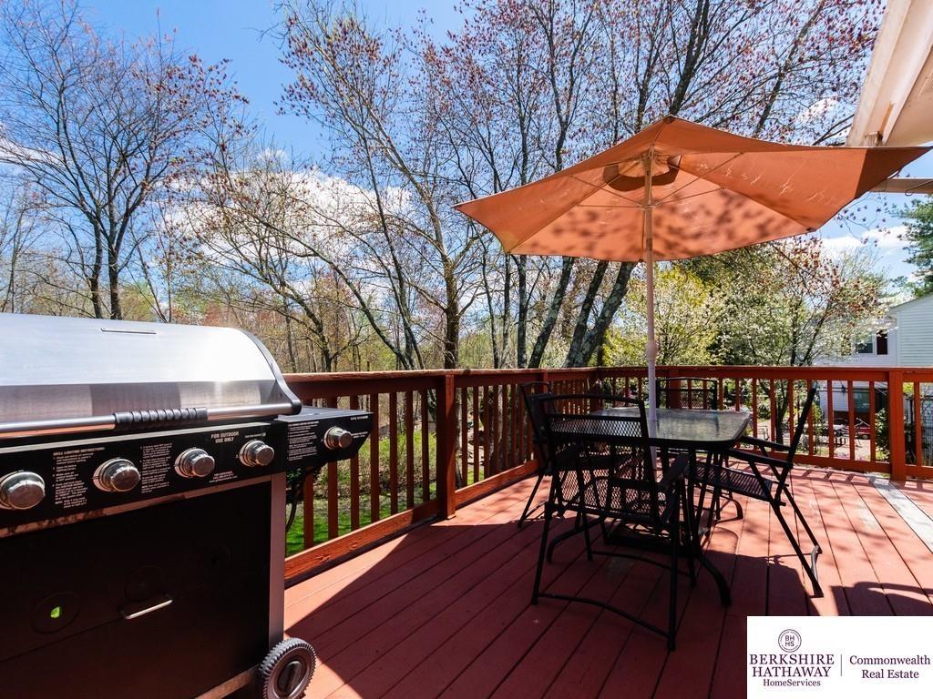 93 Graymore Road Waltham, MA 02451 - Photo 22 of 32 a view of balcony with wooden floor outdoor seating and trees